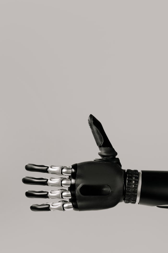 services-02 A detailed image of a futuristic robotic prosthetic hand with a neutral background.